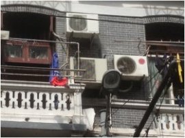 A large, urban apartment building is shown, using mini-split methods – a number of per apartment.