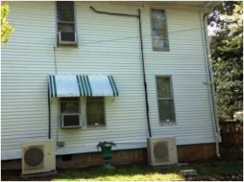 a normal U.S. design residence is shown here with a retrofit mini-split system. Spot the exterior line units and condensate drains. Thermal losings could be anticipated through the vertical, outside refrigerant lines that might cause the device to have difficulty keeping up on truly hot days. Additionally, notice that the window-room air conditioning units never have yet already been eliminated.